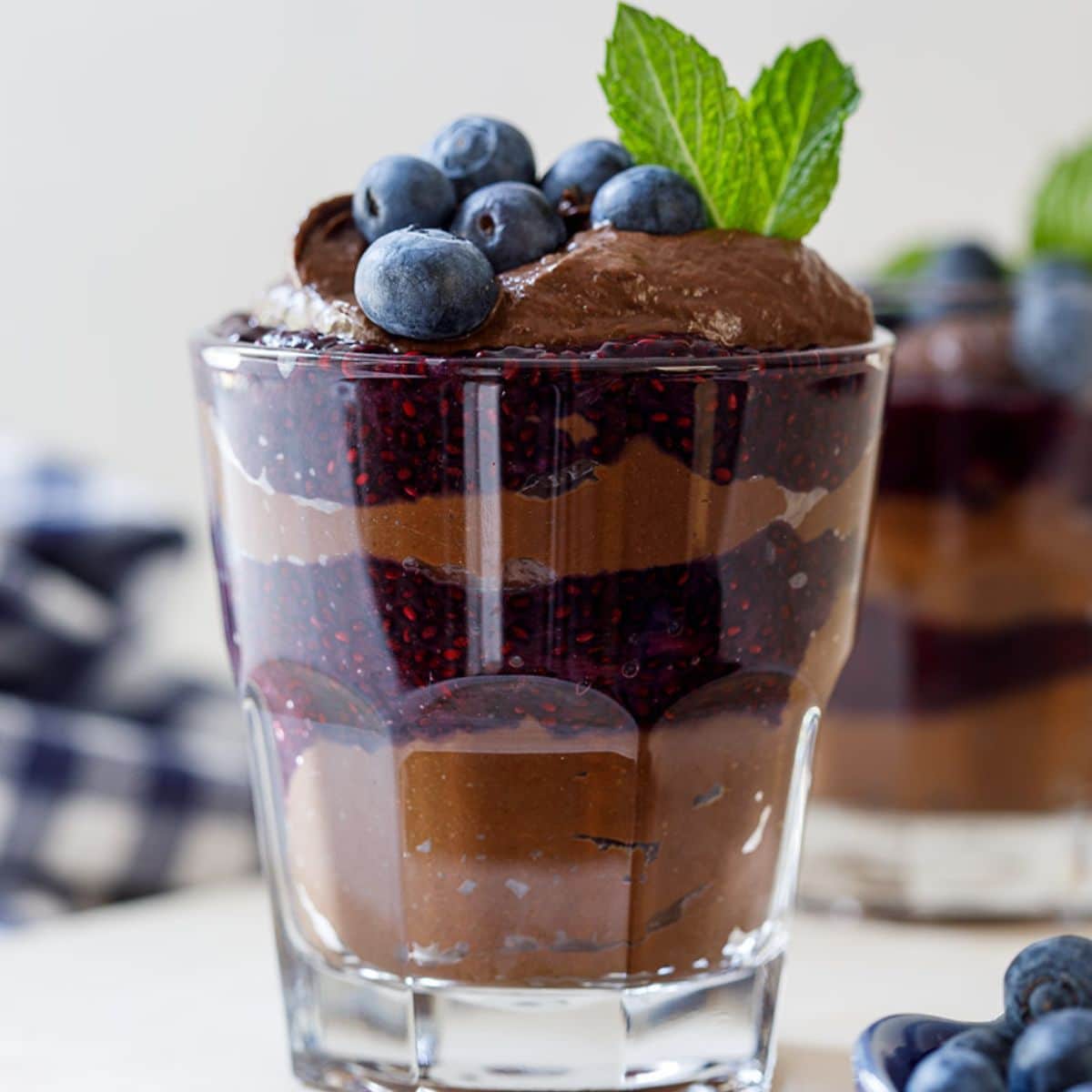 Blueberry Chocolate Chia Parfait in a glass cup.