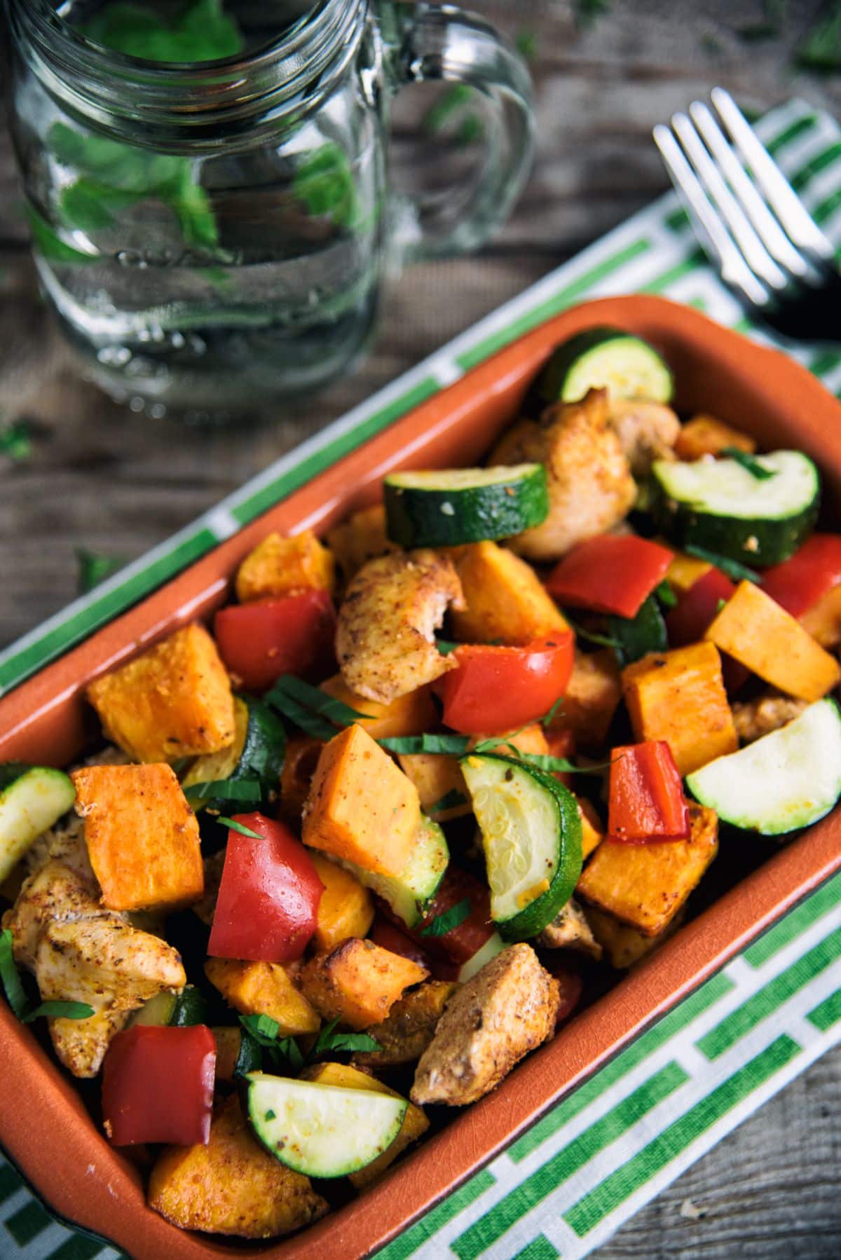 Cajun-Style Chicken With Vegetables in an orange bowl.