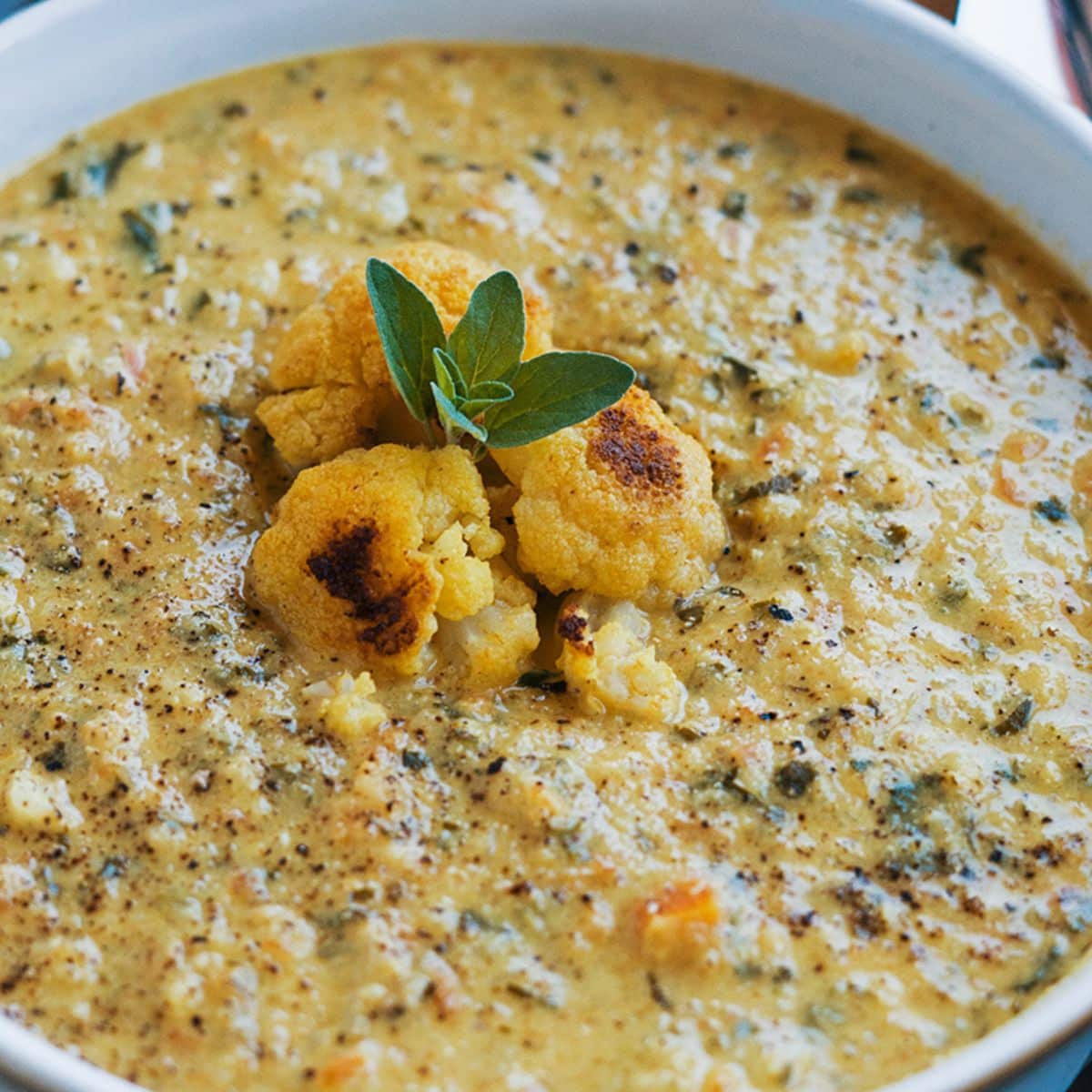 Curried Cauliflower And Kale Soup in a bowl.