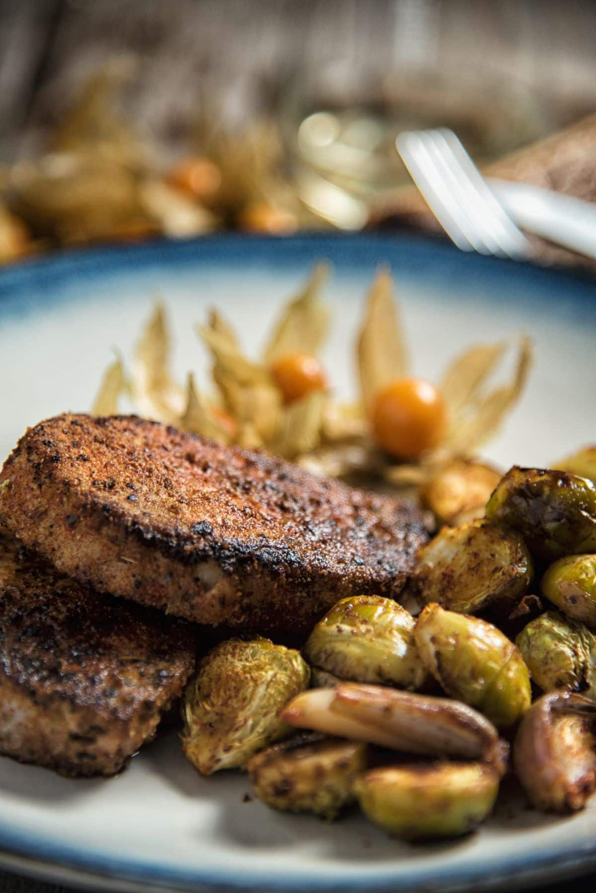 Paprika Pork Chops with Brussels Sprouts on a white plate.