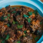 Slow Cooker Moroccan Lamb Stew in a blue bowl.