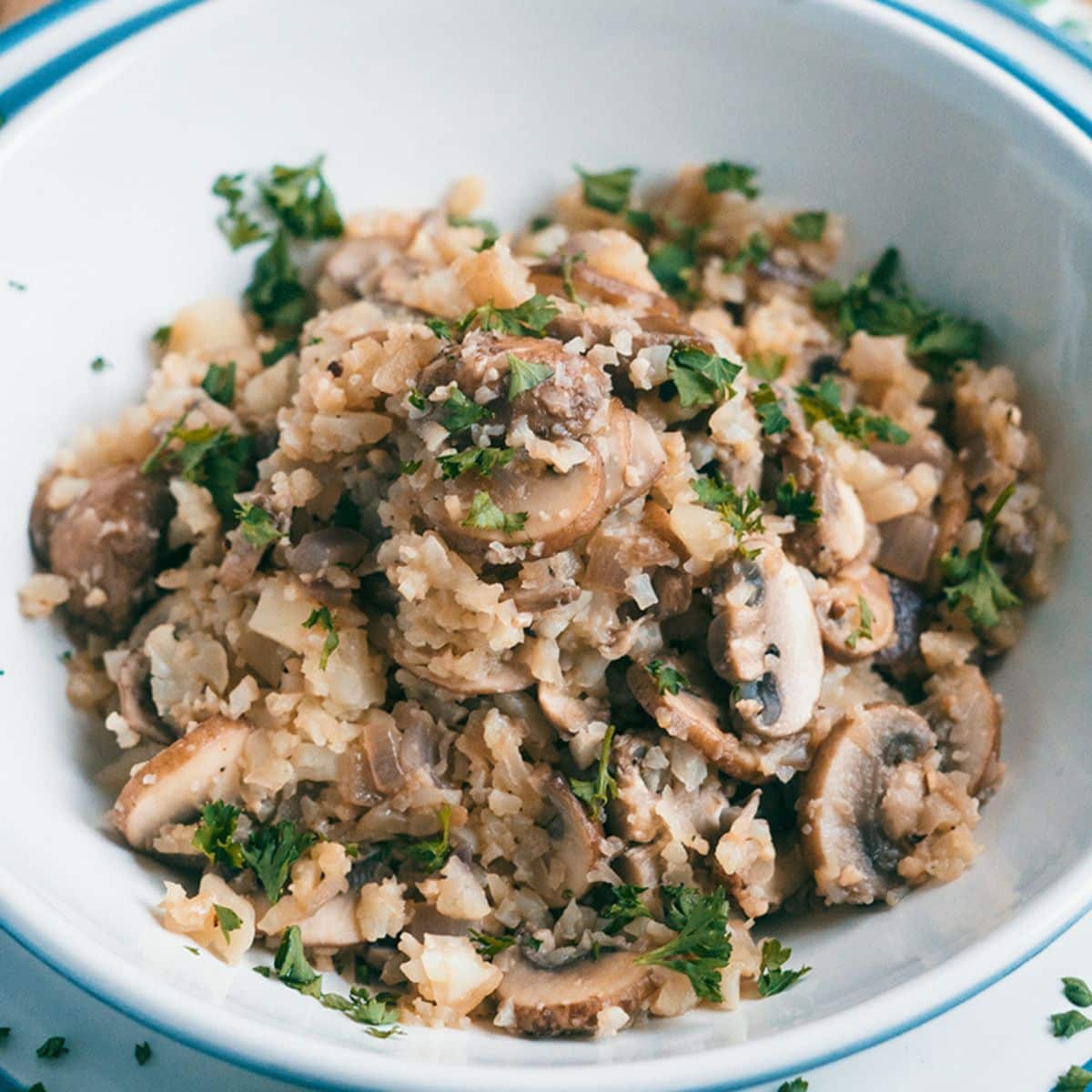 Cauliflower Mushroom Risotto in a white bowl.