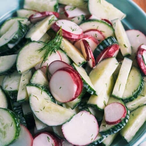 Cucumber And Radish Salad in a blue bowl.