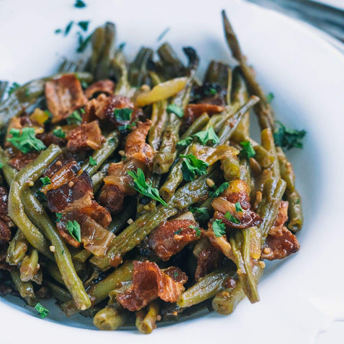 Slow Cooker BBQ Bacon Green Beans on a white plate.