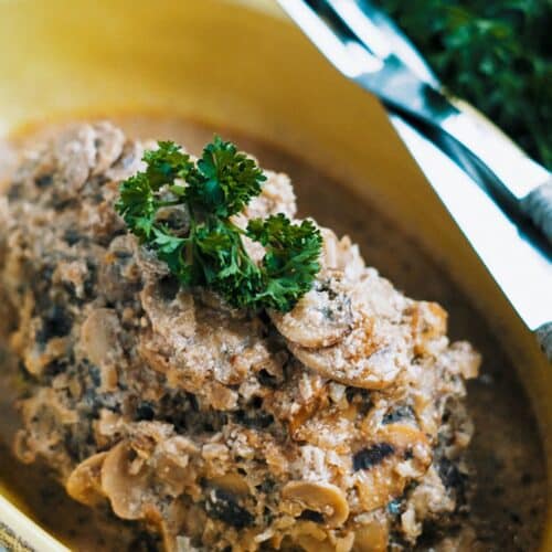 Slow Cooker Beef With Mushroom-Onion Sauce Recipe in a yellow bowl.