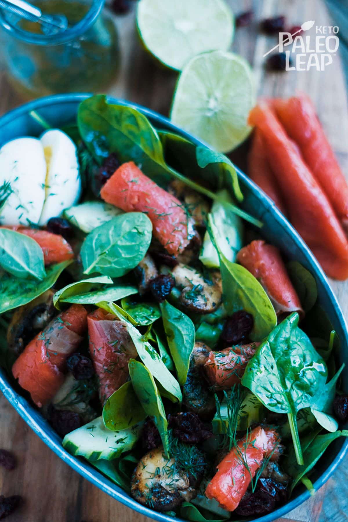 Keto Smoked Salmon Salad With Spinach And Mushrooms in a blue bowl.