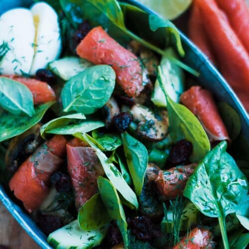 Keto Smoked Salmon Salad With Spinach And Mushrooms in a blue bowl.