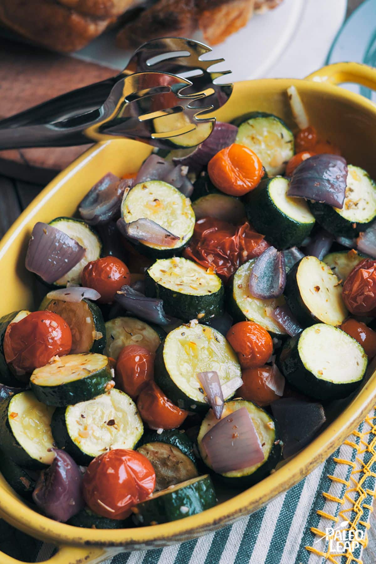 Roasted Italian Zucchini and Tomatoes in a yellow bowl.