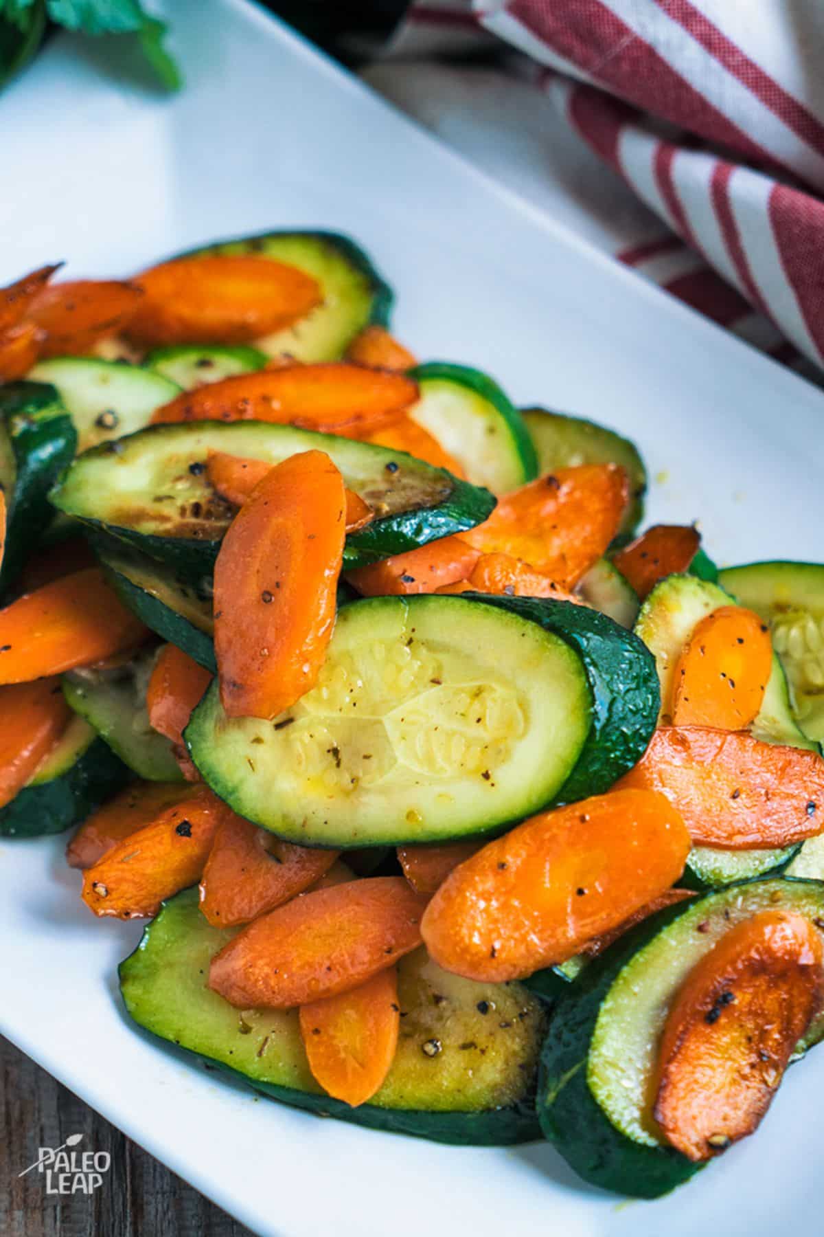 Sautéed Carrots And Zucchini on a white plate.