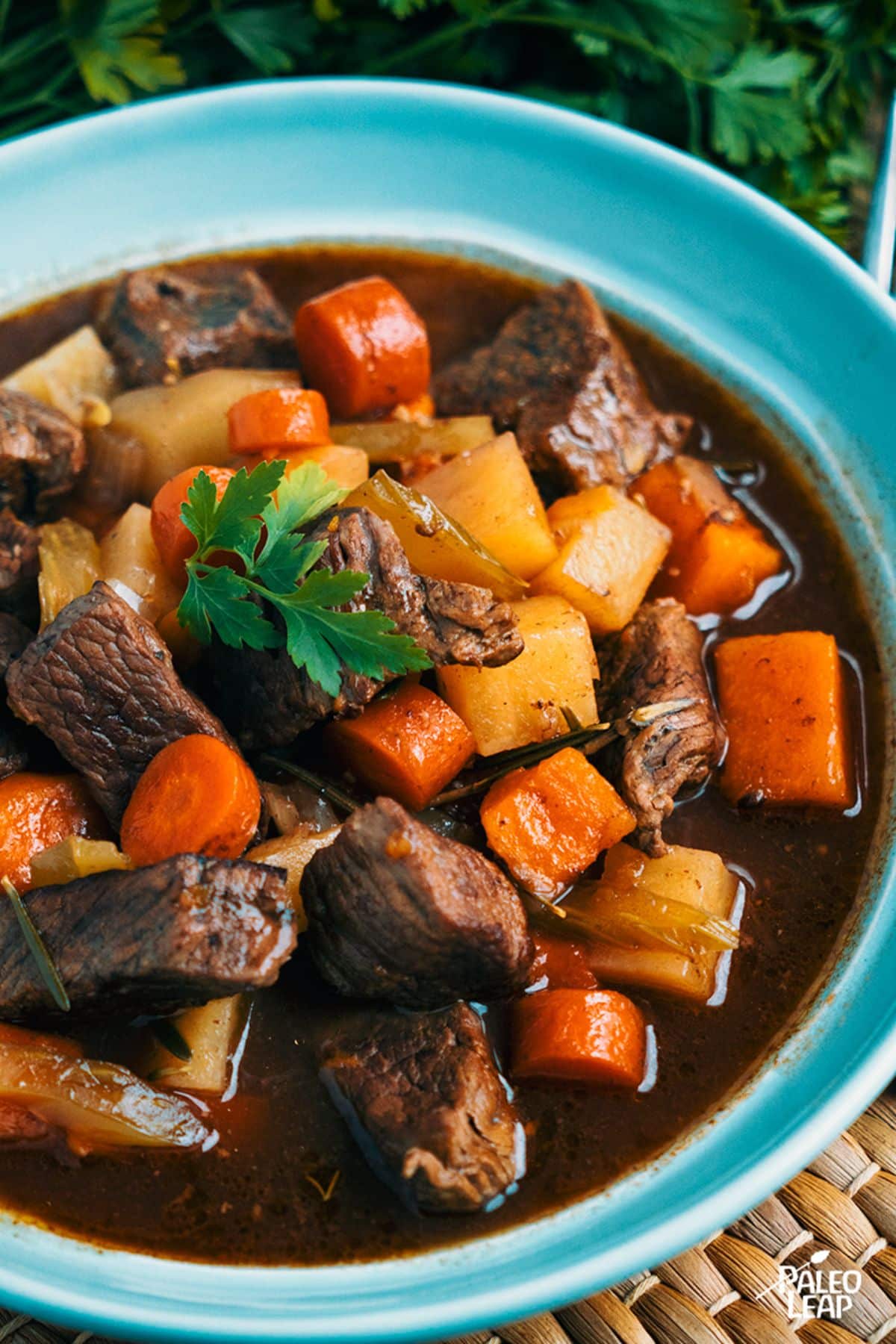 Slow Cooker Beef And Rutabaga Stew in a blue bowl.