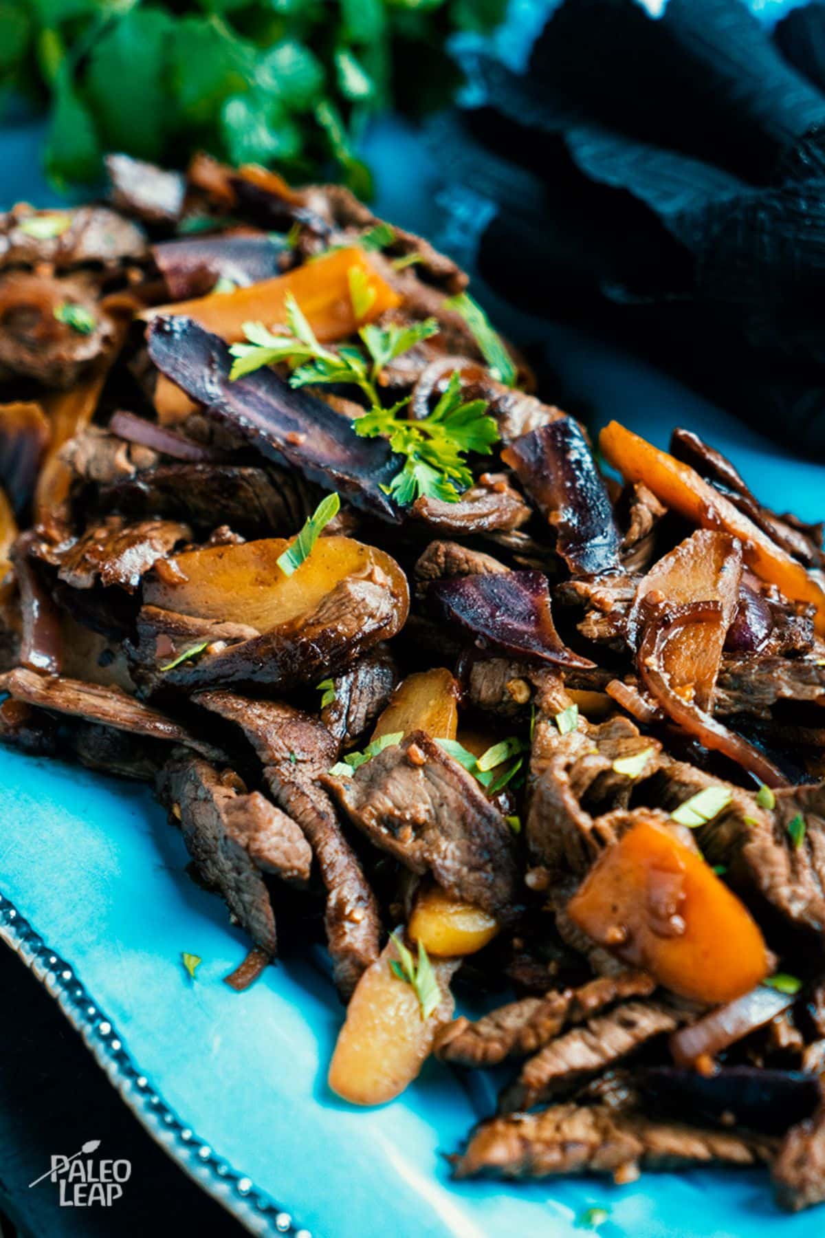 Ginger Beef And Carrots on a blue tray.
