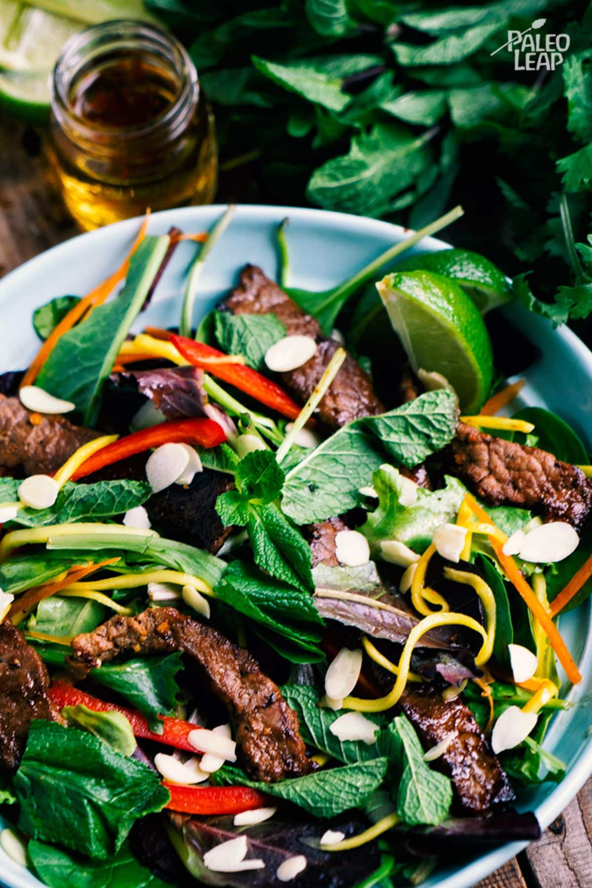 Vietnamese-Style Beef And Mango Salad in a blue bowl.