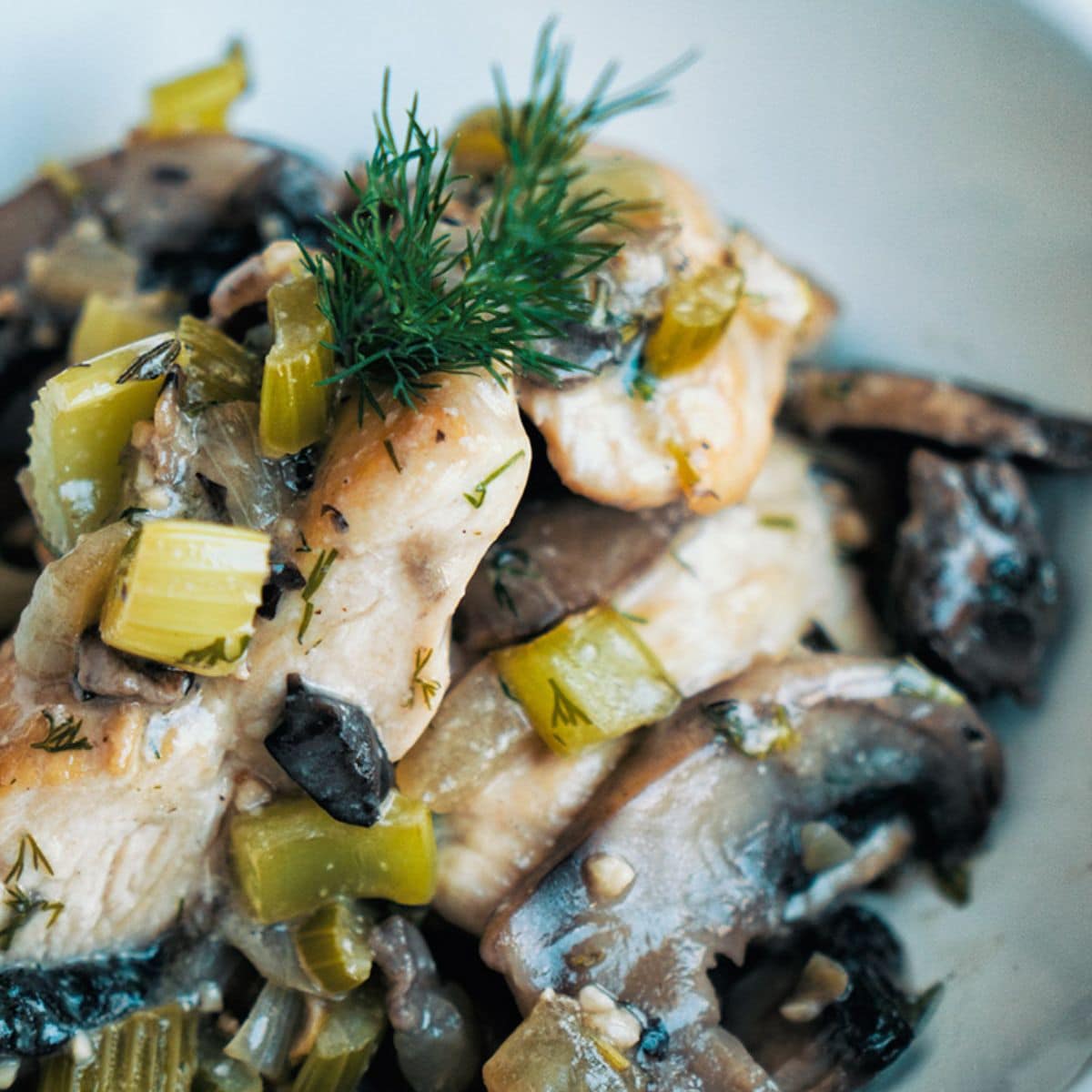 Country Style Chicken And Mushrooms in a white bowl.