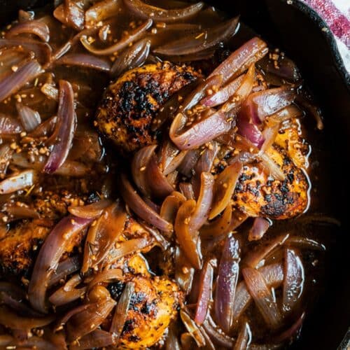 Oven-Baked French Onion Chicken in a black pan.