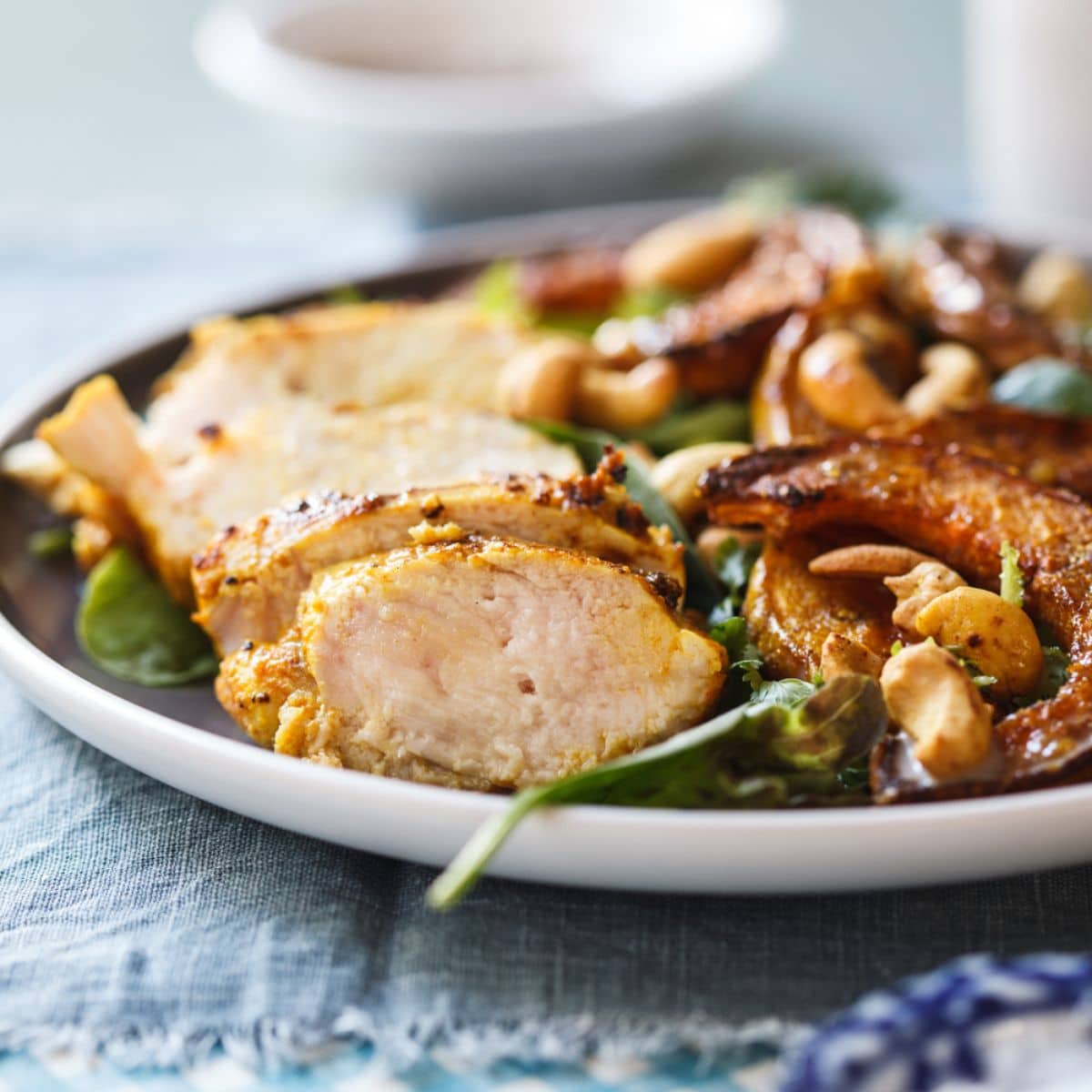 Indian-Spiced Chicken and Roasted Butternut Salad on a white plate.