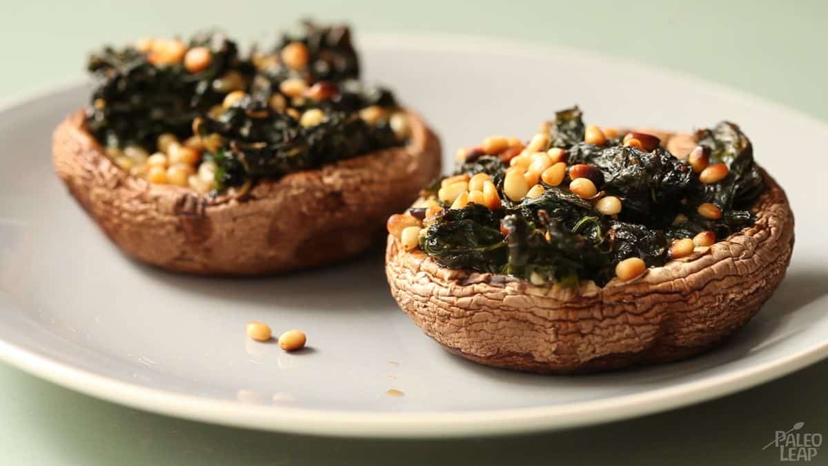Garlic-Butter Spinach-Stuffed Mushrooms on a white plate.