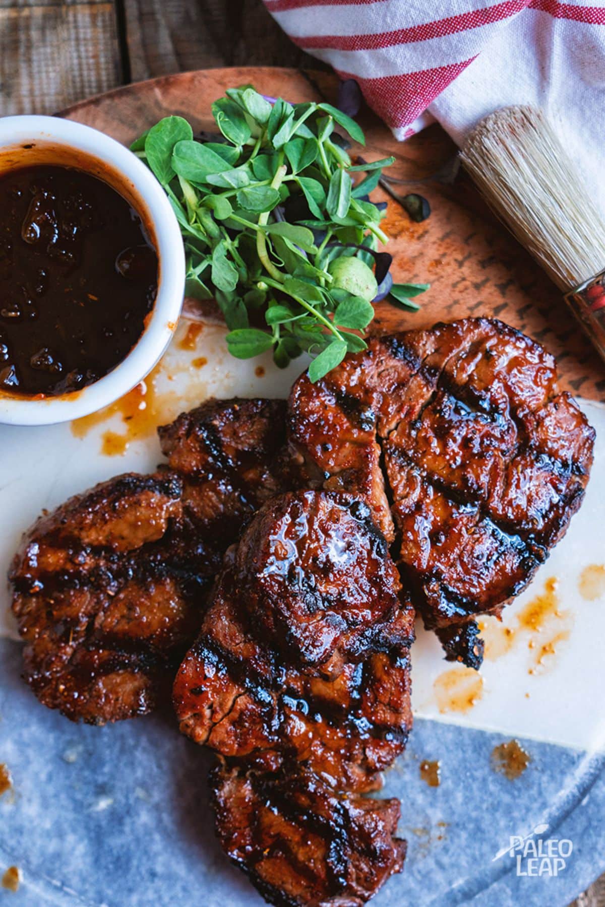 Cajun-Style Steak With Spicy Mango Glaze on a wooden board.