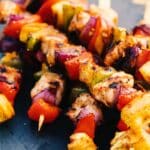 Hawaiian-Style Chicken Skewers on a table.