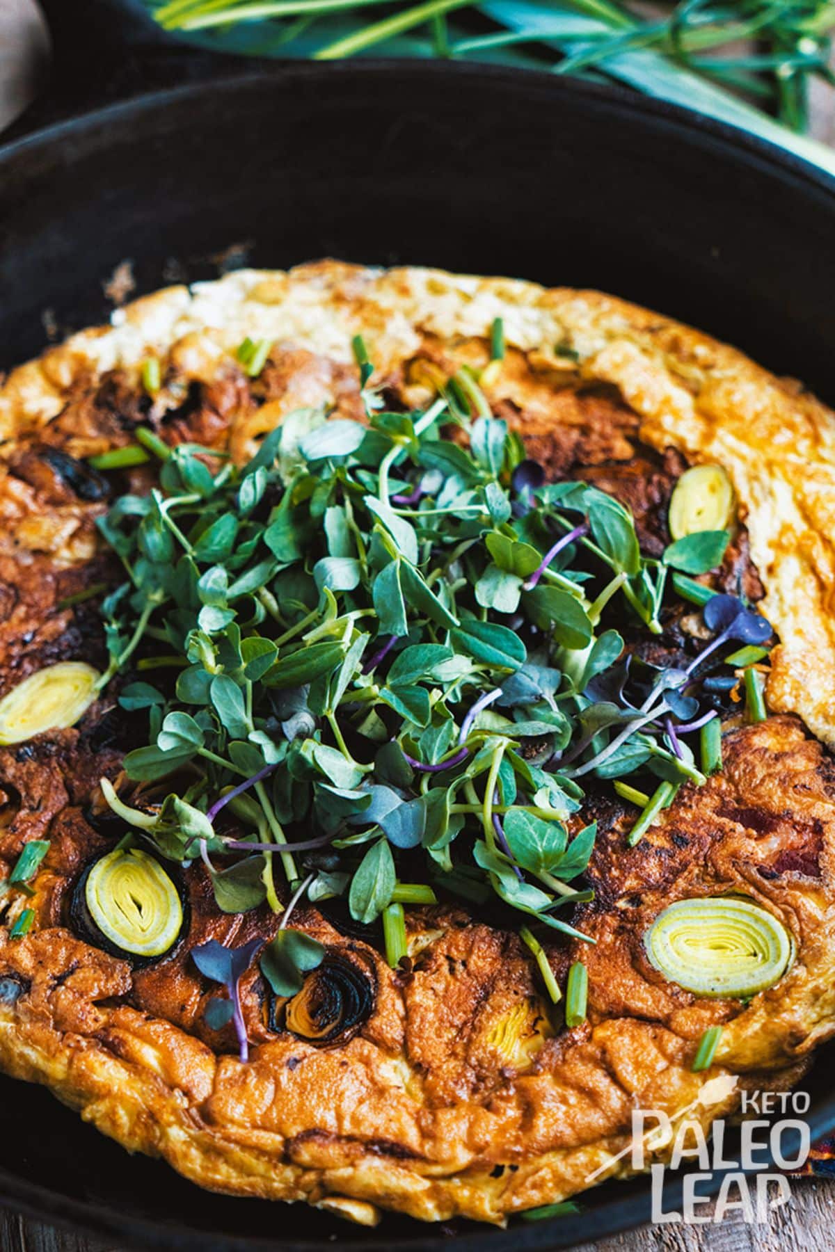 Keto Leek And Bacon Omelet in a black pan.