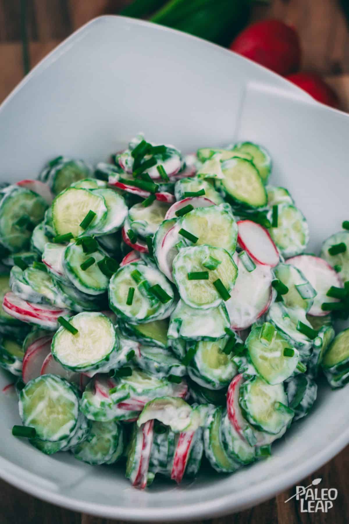 Creamy Cucumber And Chive Salad in a white bowl.