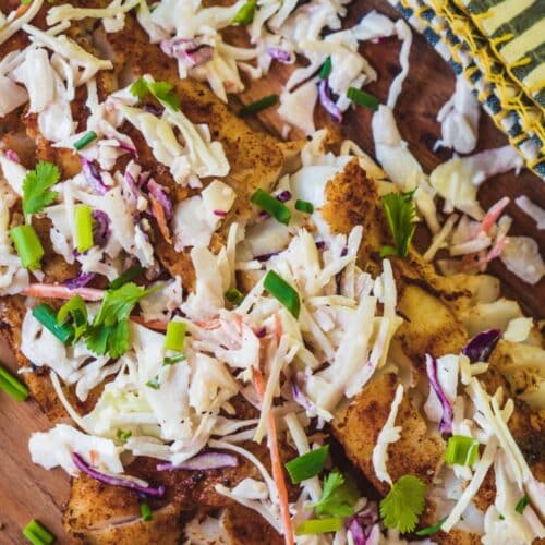 Spicy Fish With Cabbage Slaw on a wooden board.