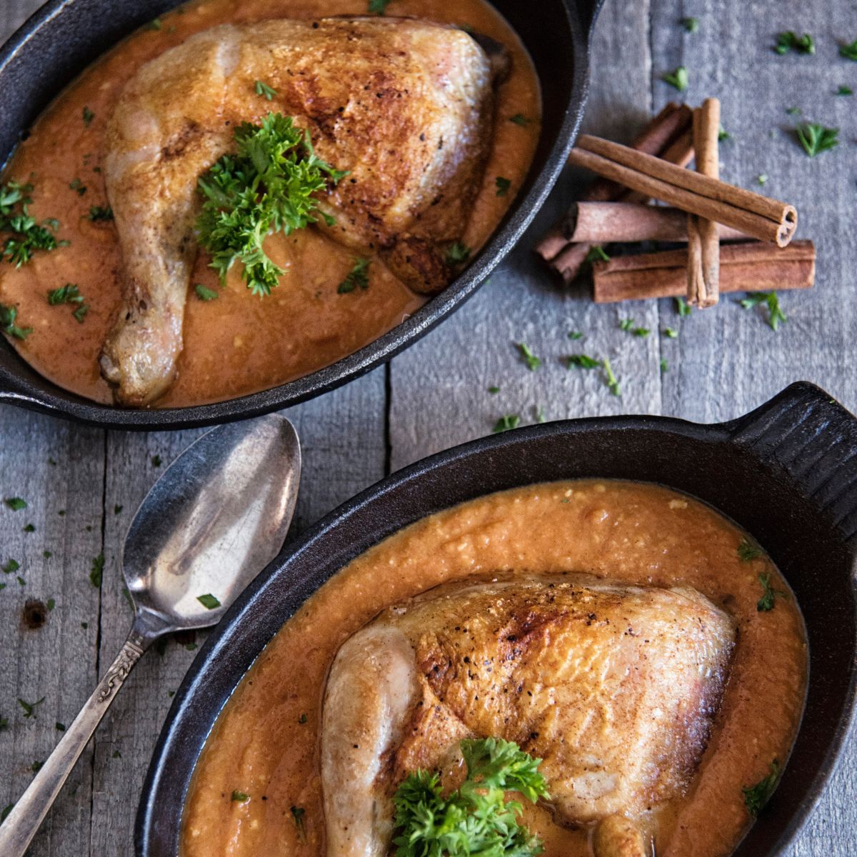 Chicken with Creamy Tomato Curry in two black pans.