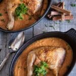 Chicken with Creamy Tomato Curry in two black pans.