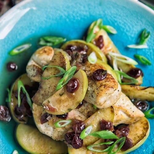 Chicken with Apples and Cranberries on a blue plate.