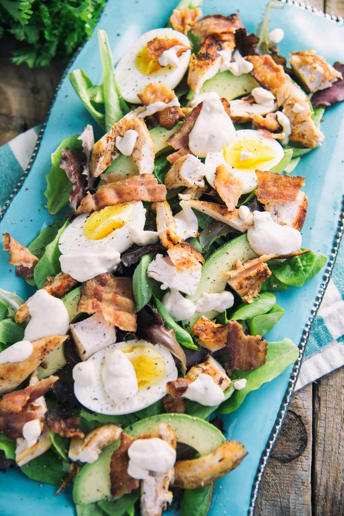 Keto Chicken and Bacon Loaded Salad on a blue tray.