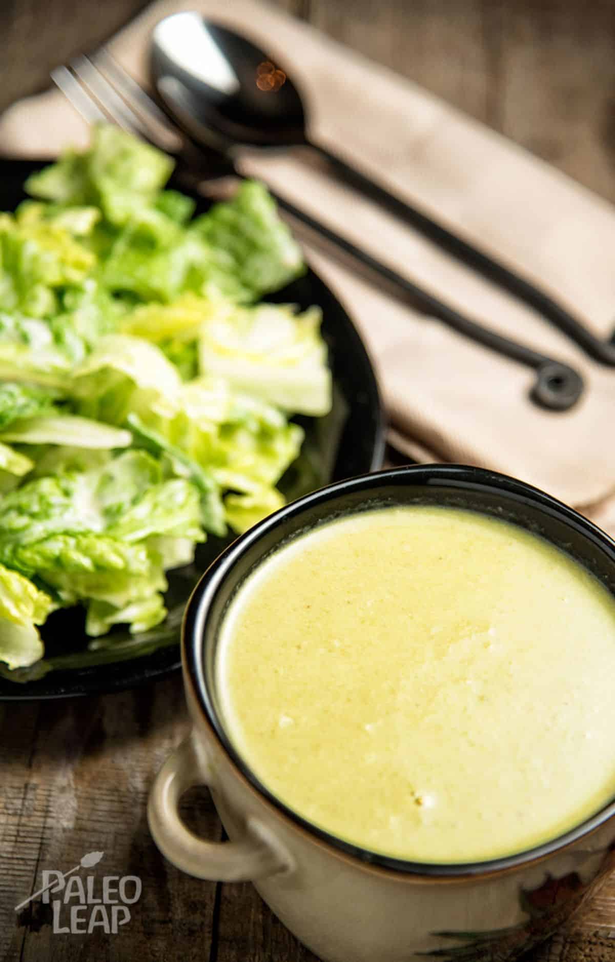 Creamy Asparagus Soup with Roasted Garlic Caesar Salad Recipe on a table.
