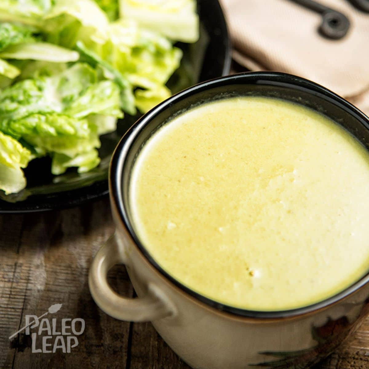 Creamy Asparagus Soup with Roasted Garlic Caesar Salad Recipe on a table.