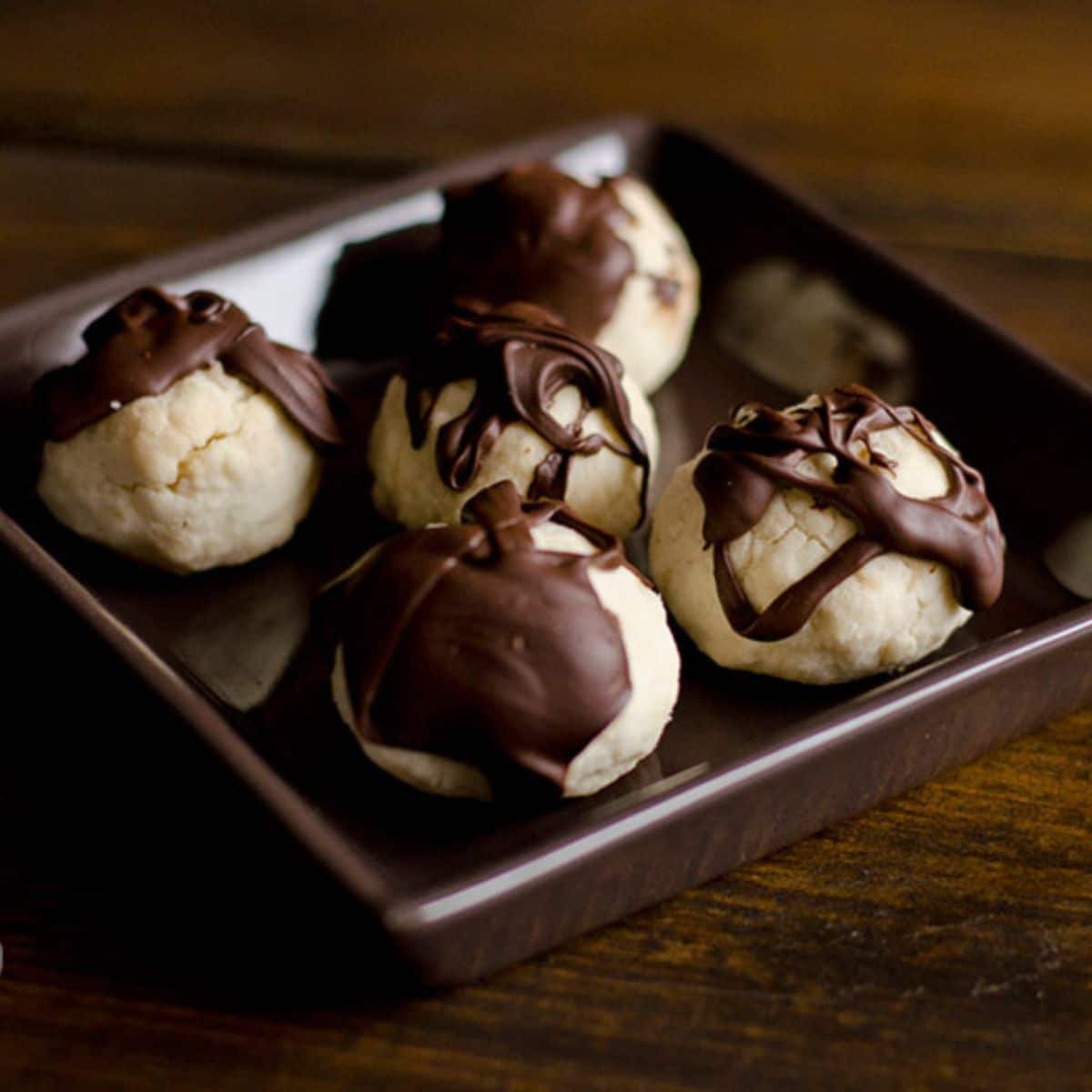 Paleo Dark Chocolate-Drizzled Shortbreads in a brown bowl.