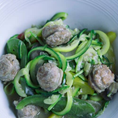 Zucchini Noodles With Sausage in a white bowl.