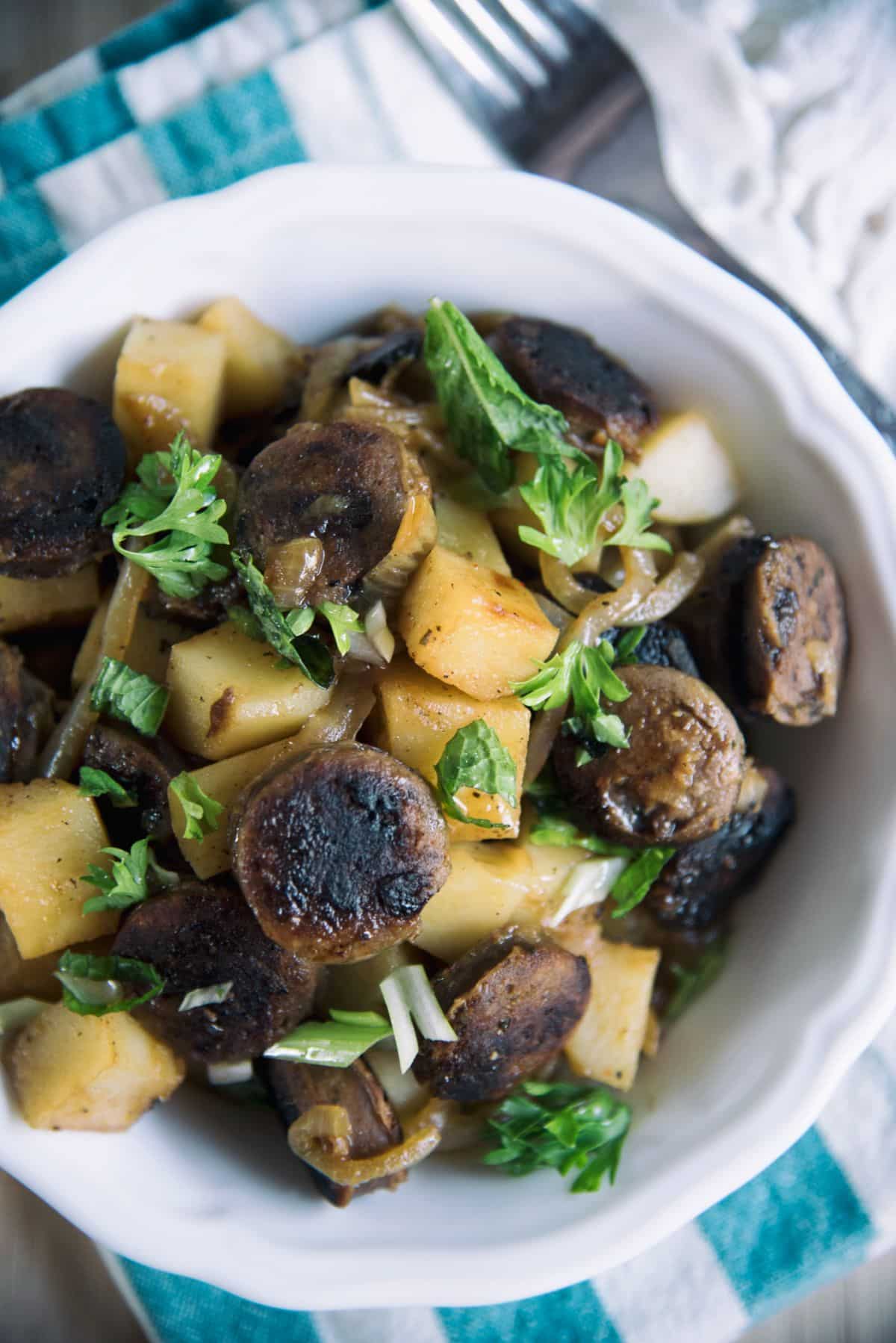 Sausage And Potato Goulash in a white bowl.