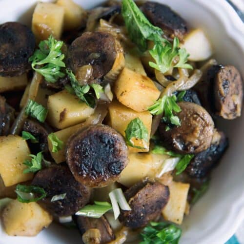 Sausage And Potato Goulash in a white bowl.