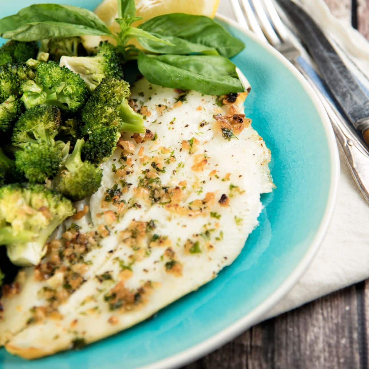 Broiled Halibut with Broccoli and Toasted Garlic on a blue plate.