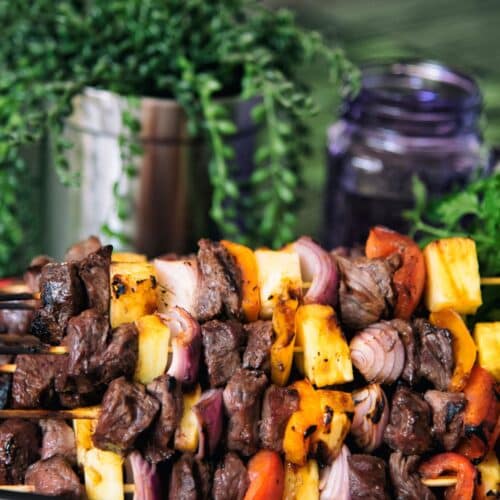 Grilled Steak And Pineapple Skewers on a tray.