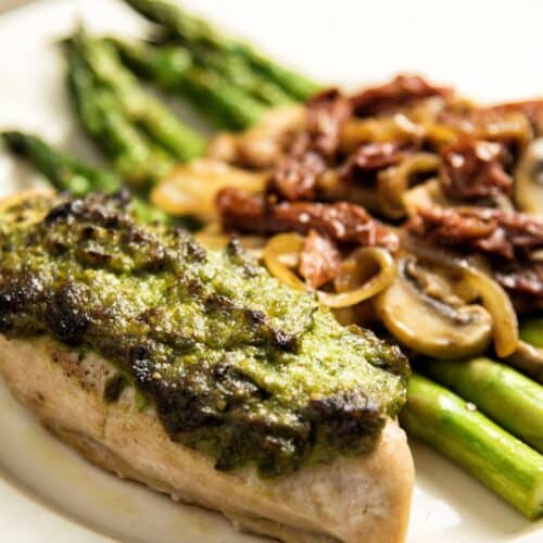 Herb Roasted Chicken Breasts With Pan-Fried Vegetables on a white plate.