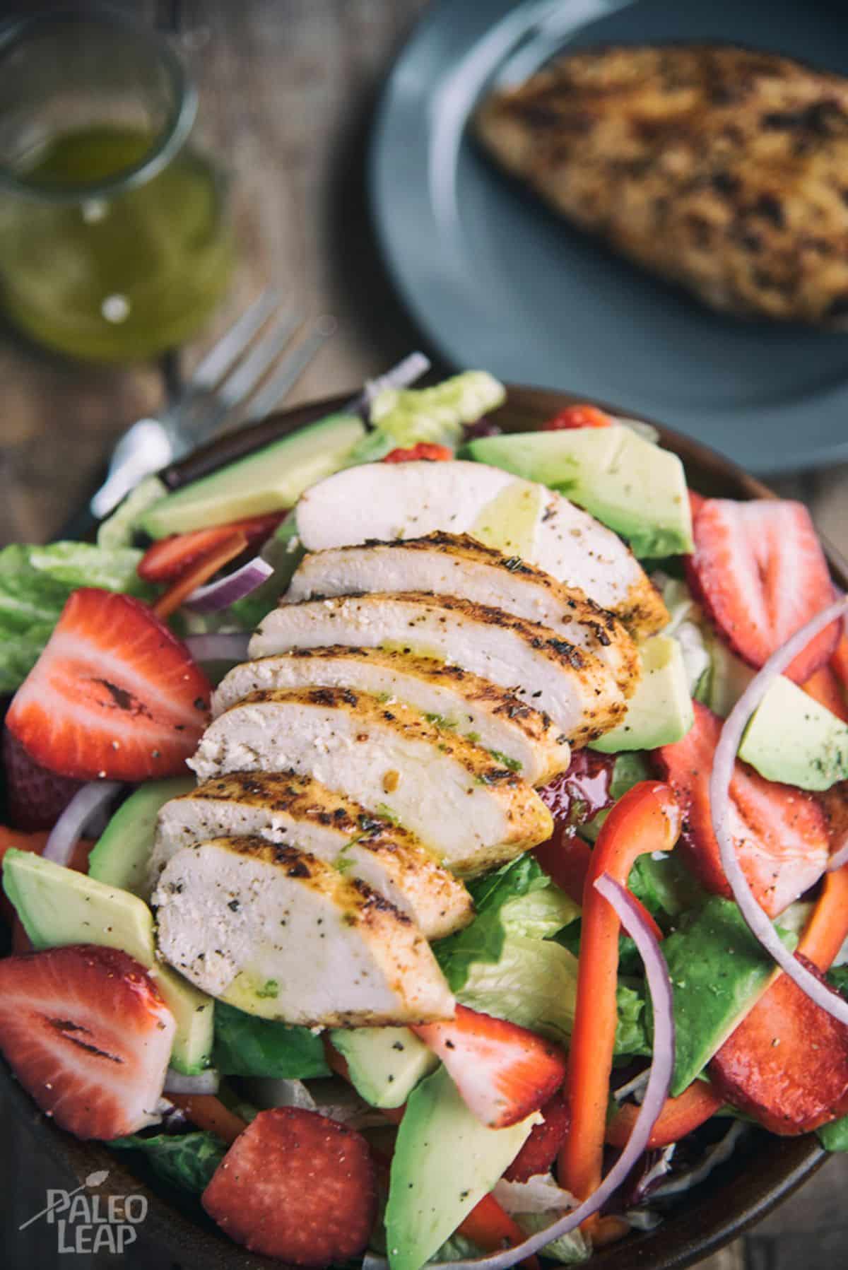 Tuscan Grilled Chicken With Strawberry Salad  on a plate.