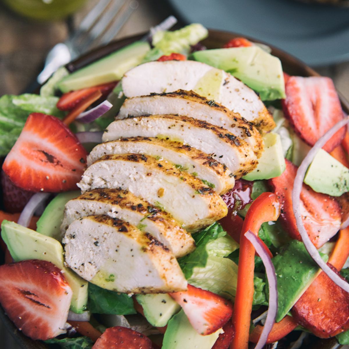 Tuscan Grilled Chicken With Strawberry Salad on a plate.