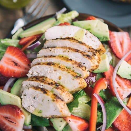 Tuscan Grilled Chicken With Strawberry Salad on a plate.