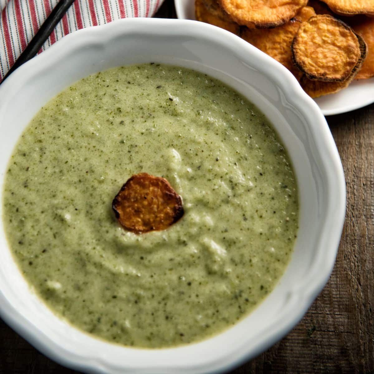 Zucchini Soup with Sweet Potato Scoops in a white bowl.