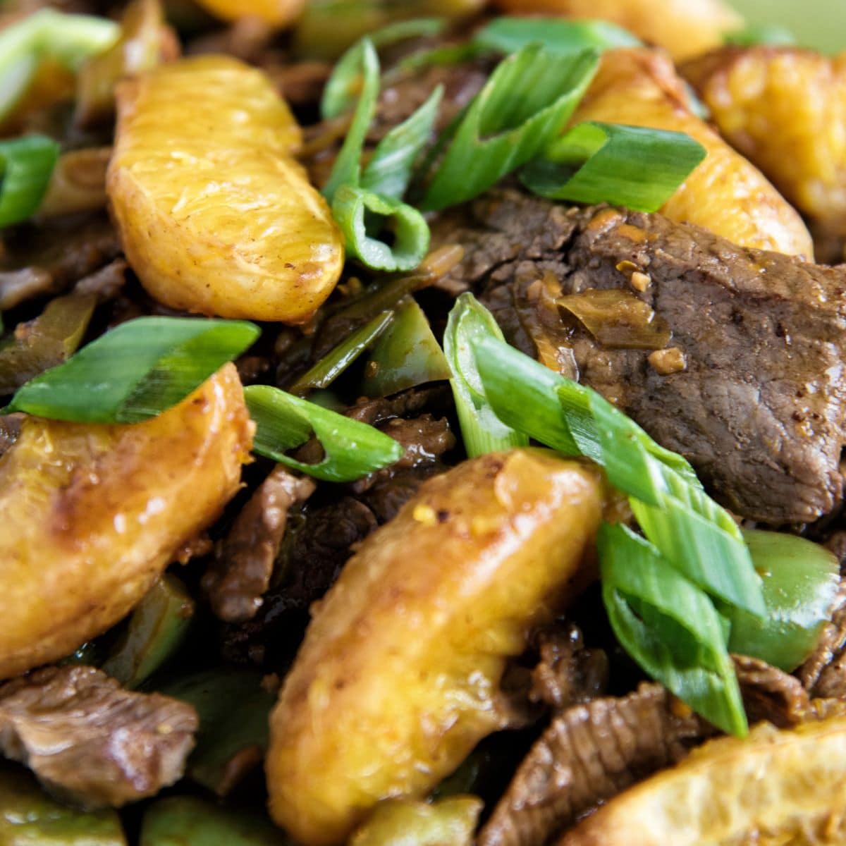 Orange and Beef Stir-Fry on a green plate.