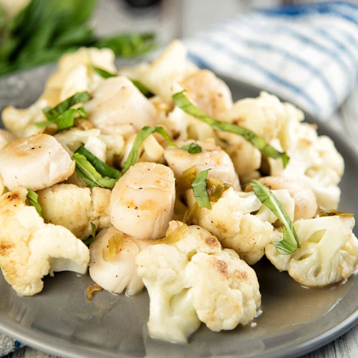 Pan-Seared Scallops with Cauliflower on a tray.