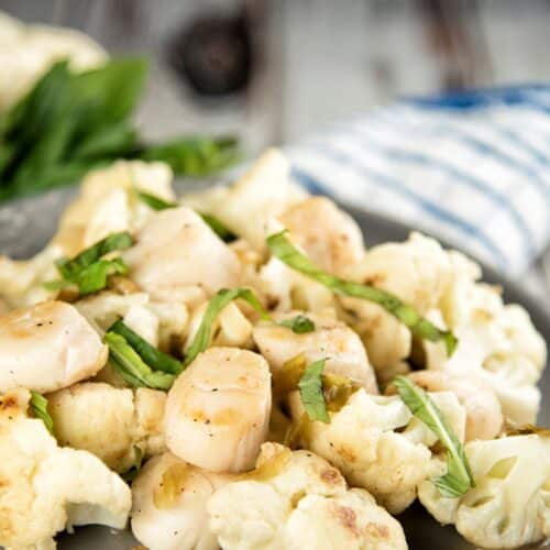 Pan-Seared Scallops with Cauliflower on a tray.