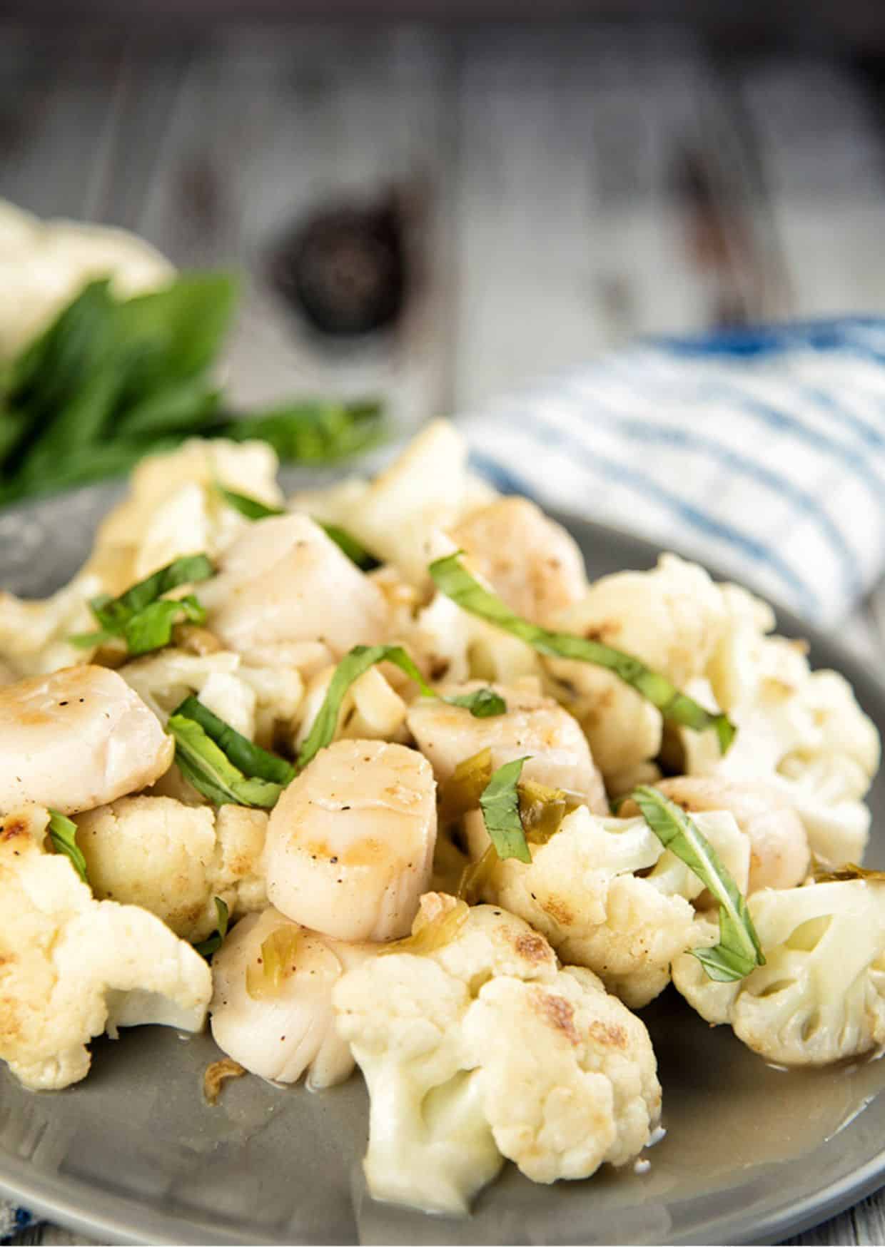 Pan-Seared Scallops with Cauliflower on a tray.