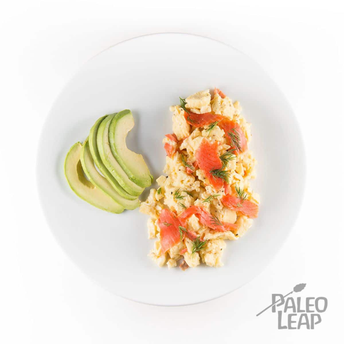 Scrambled Eggs With Smoked Salmon on a white plate.