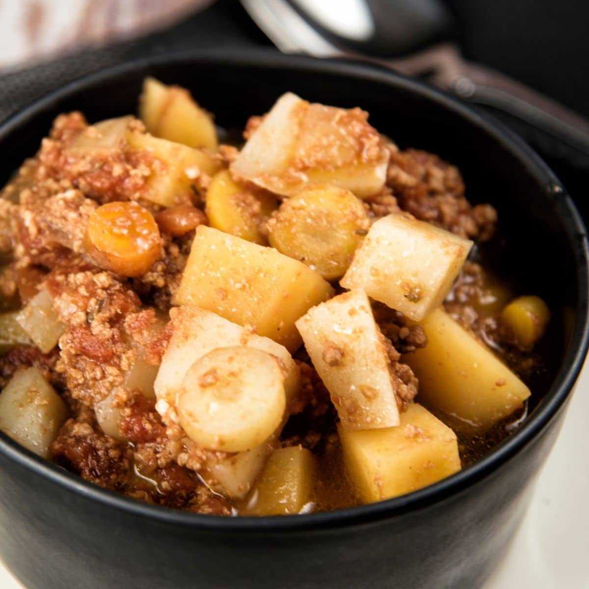 Slow Cooker Paleo Bison Stew in a black pot.