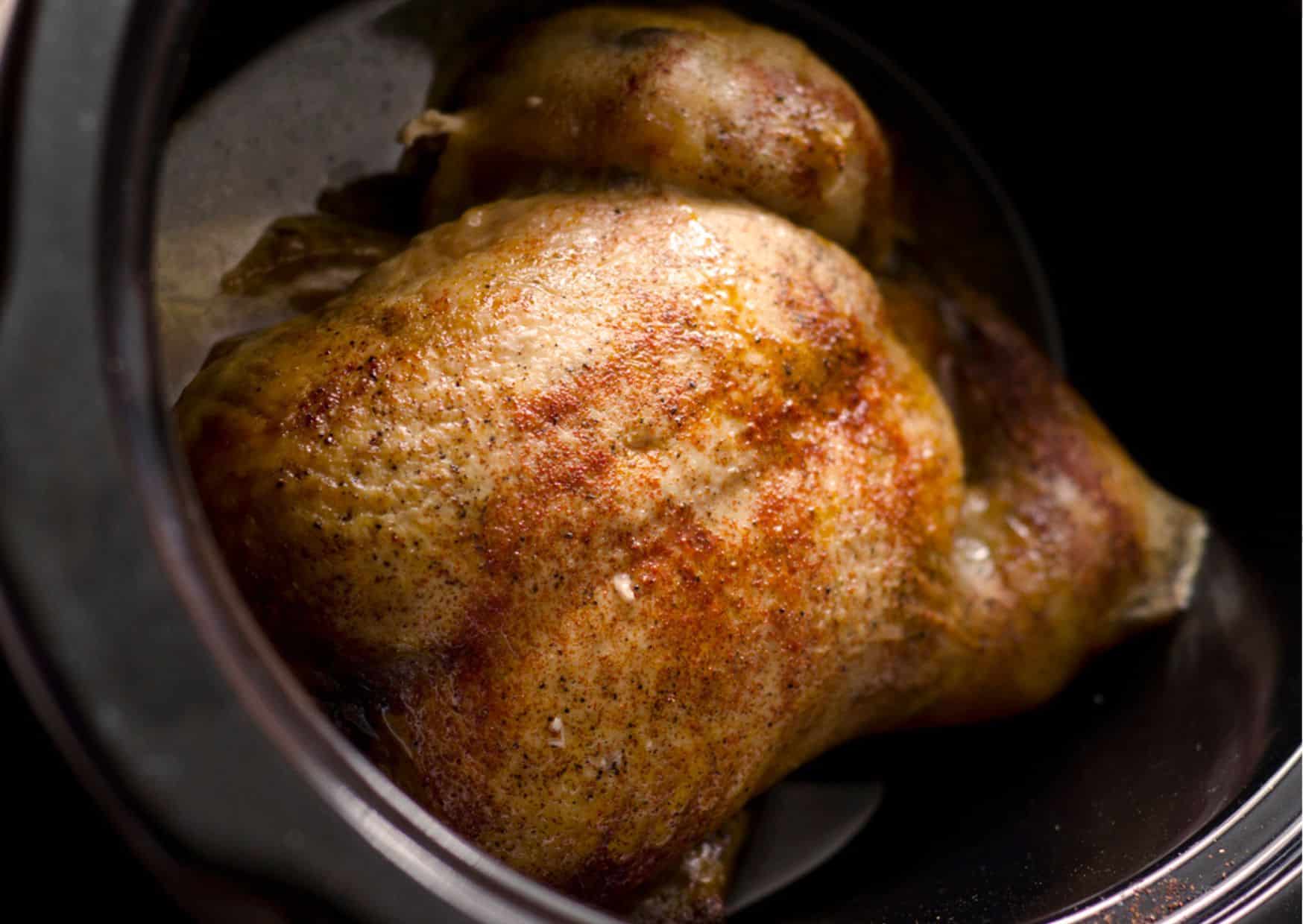 A whole chicken in a slow cooker.