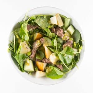 Beef, Watercress and Pear Salad in a white bowl.